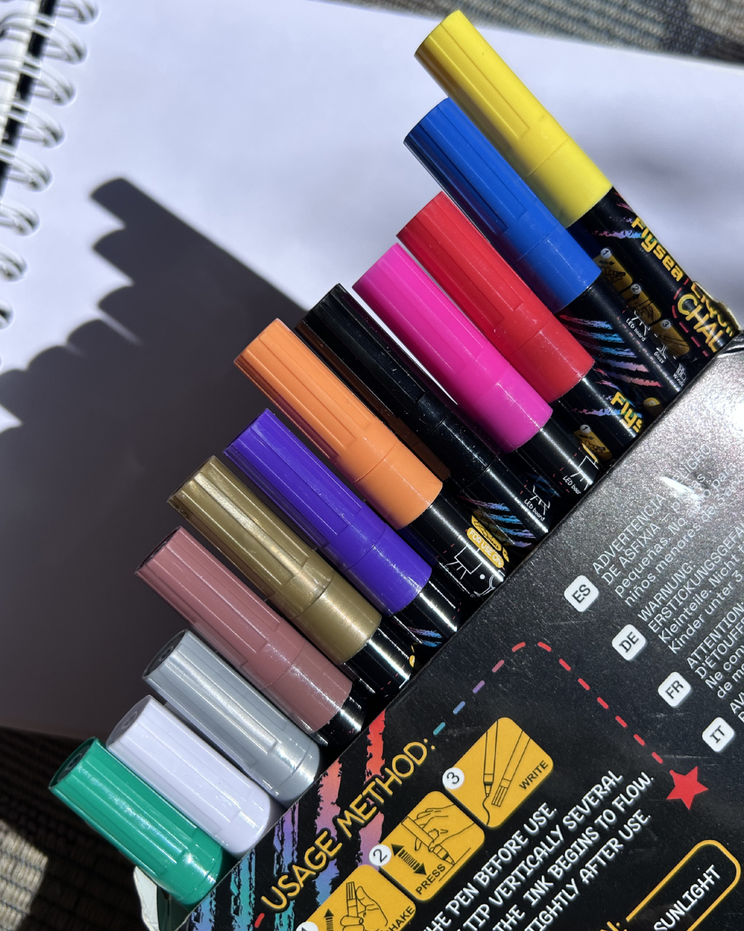 Set of colorful markers on a notebook page