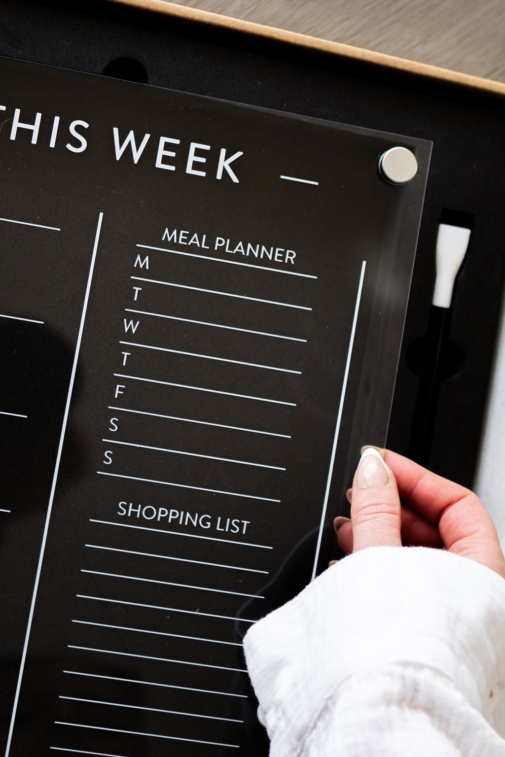 Close-up of luxury white liquid chalk pen on acrylic meal planner, styled in New Zealand kitchen.