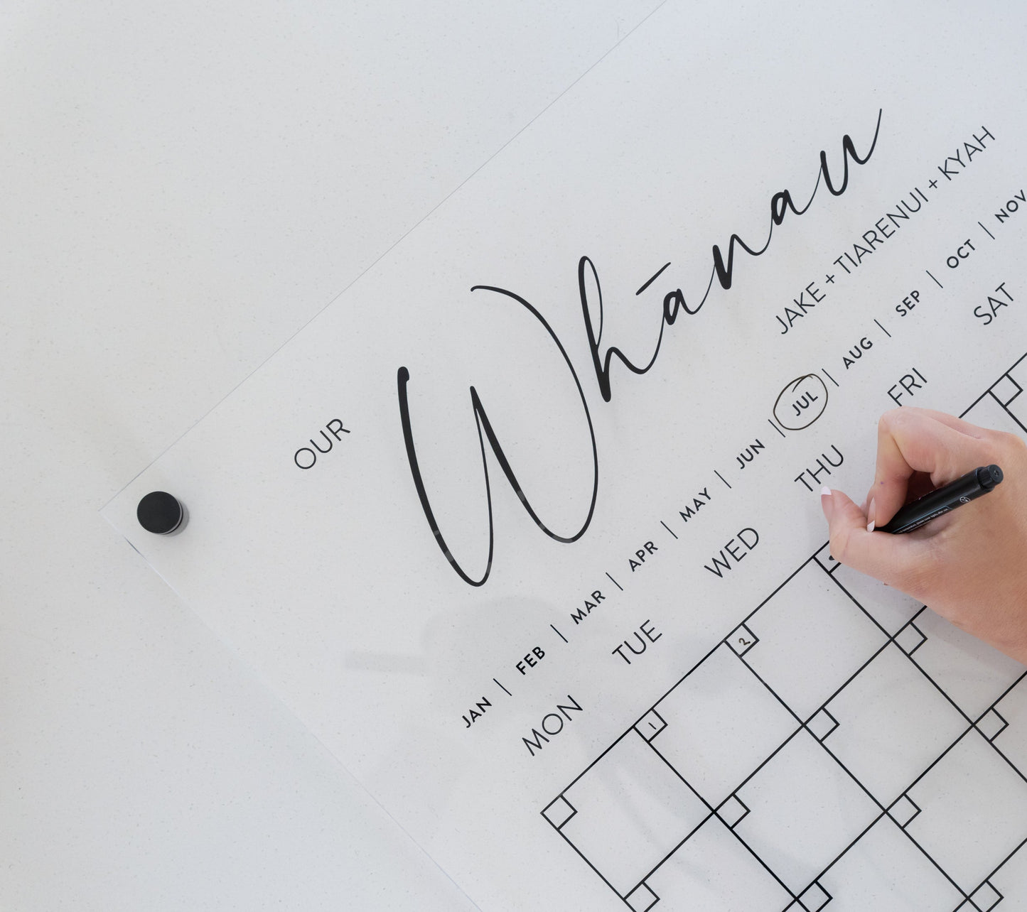 Minimalistic acrylic planner mounted with  black standoff bracket, showcasing elevated modern design.