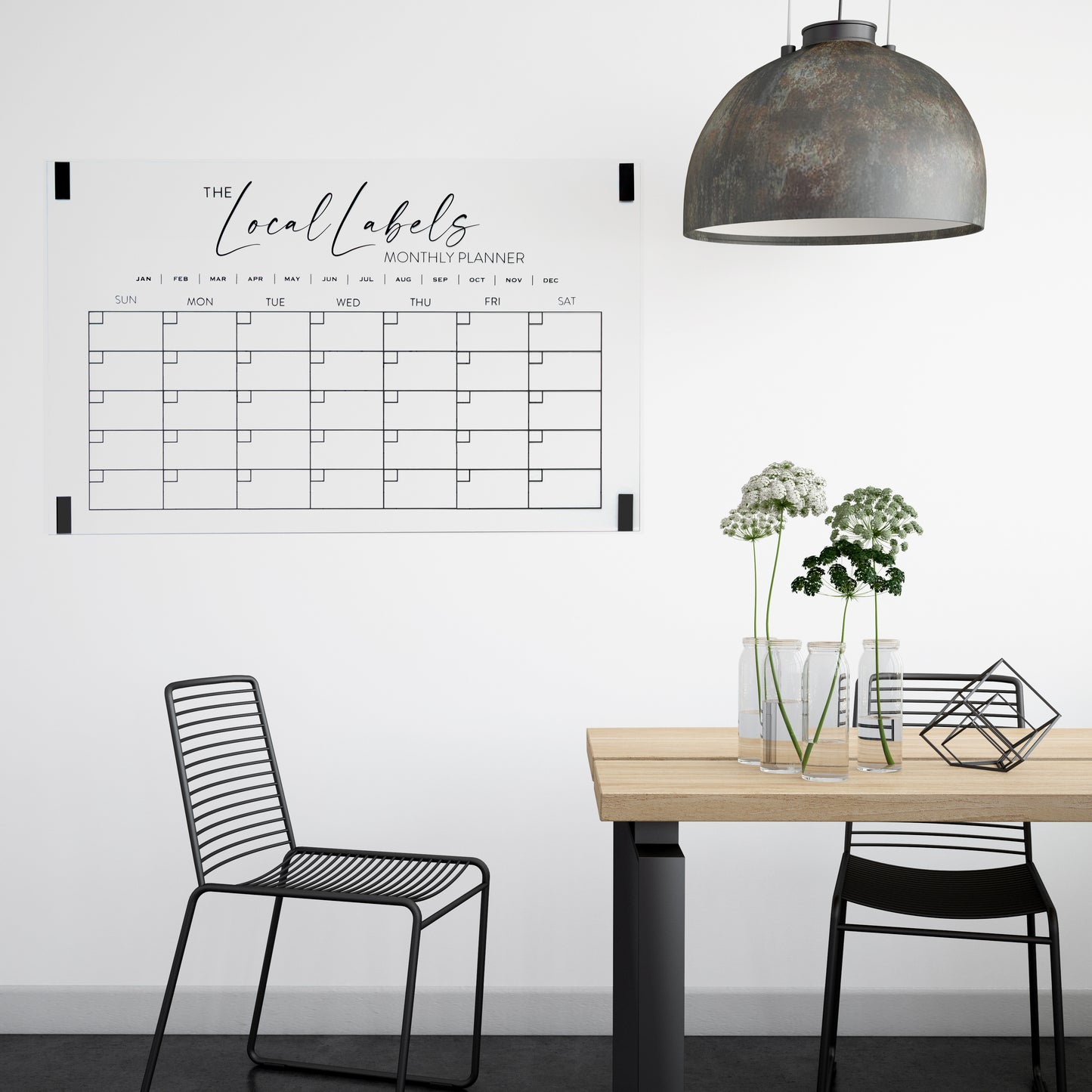 Large black acrylic monthly wall calendar mounted in a dining room using command strips, combining style and functional home organisation.