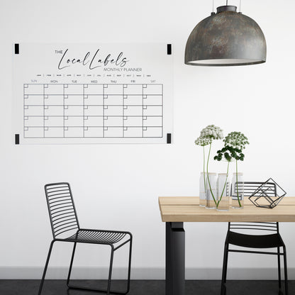 Large black acrylic monthly wall calendar mounted in a dining room using command strips, combining style and functional home organisation.