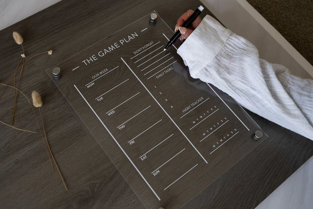 Kids acrylic Game Plan planner flat lay on desk, showing blank weekly schedule, daily tasks, chores, and habit tracker sections